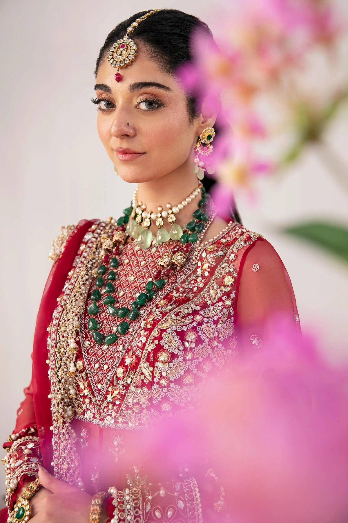 Close-up detail of ruby red organza maxi showing intricate gold embroidery, tilla work, and traditional Pakistani craftsmanship - Zaha 