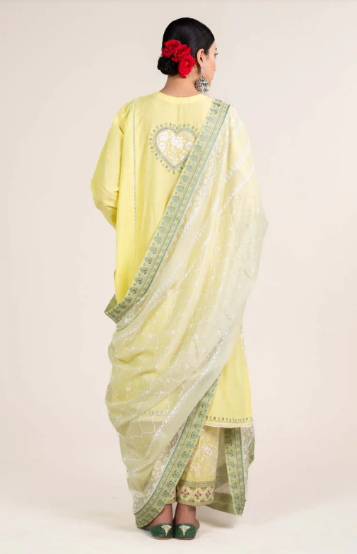 Woman wearing Zara Shahjahan back view full length lime-yellow kurta heart embroidery mint dupatta sage pants Pakistani suit Canada
