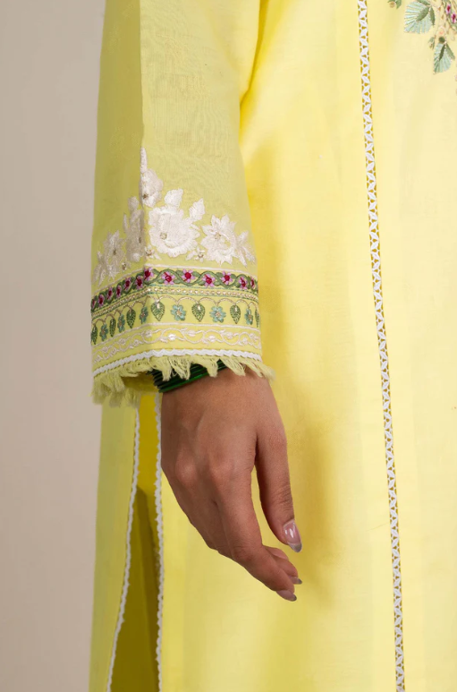 Woman wearing Zara Shahjahan close-up sleeve cuff lime-yellow jacquard white floral appliqué zardozi lace trim Pakistani suit Canada